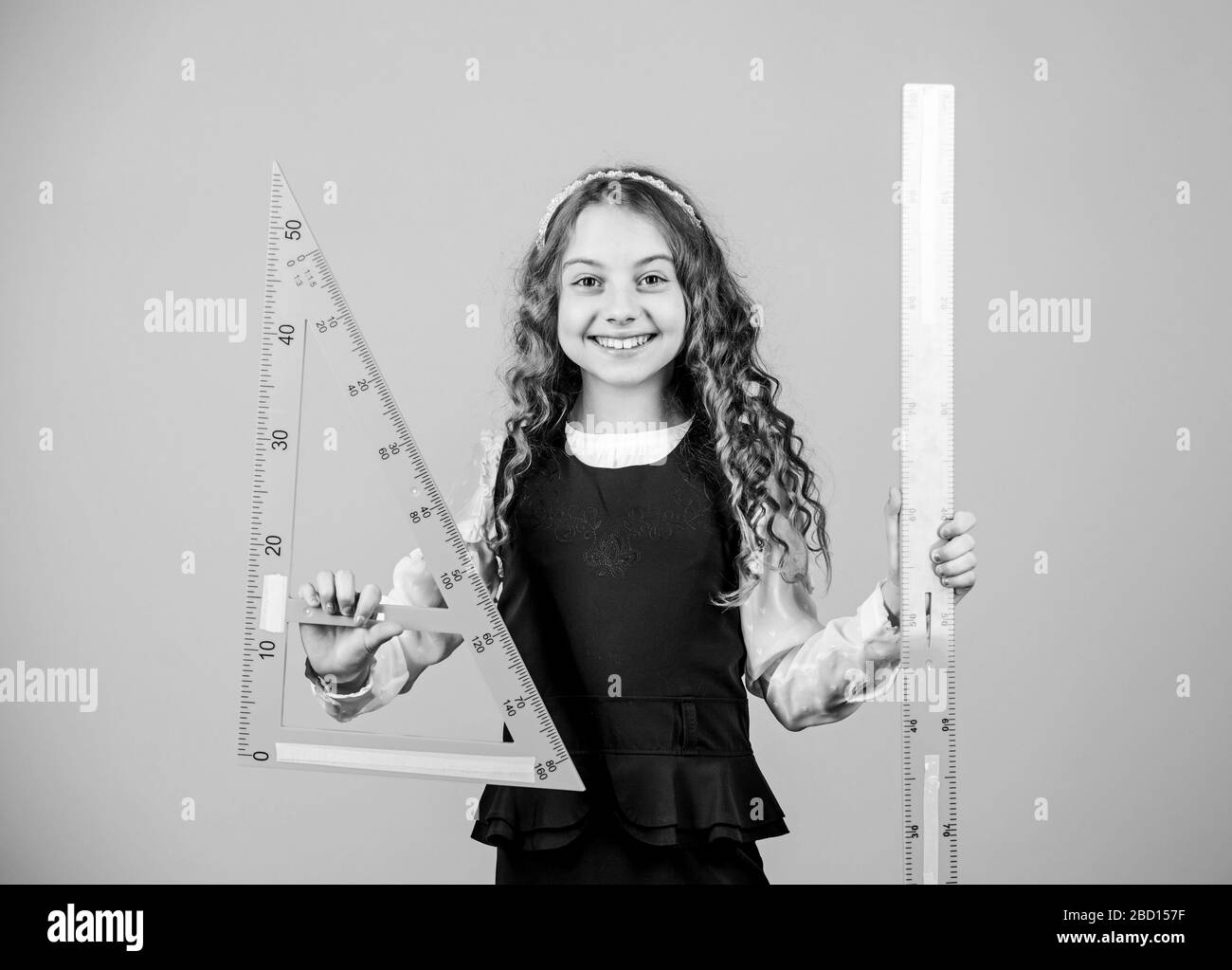 Pupil girl with big rulers. STEM school disciplines. math lesson ...