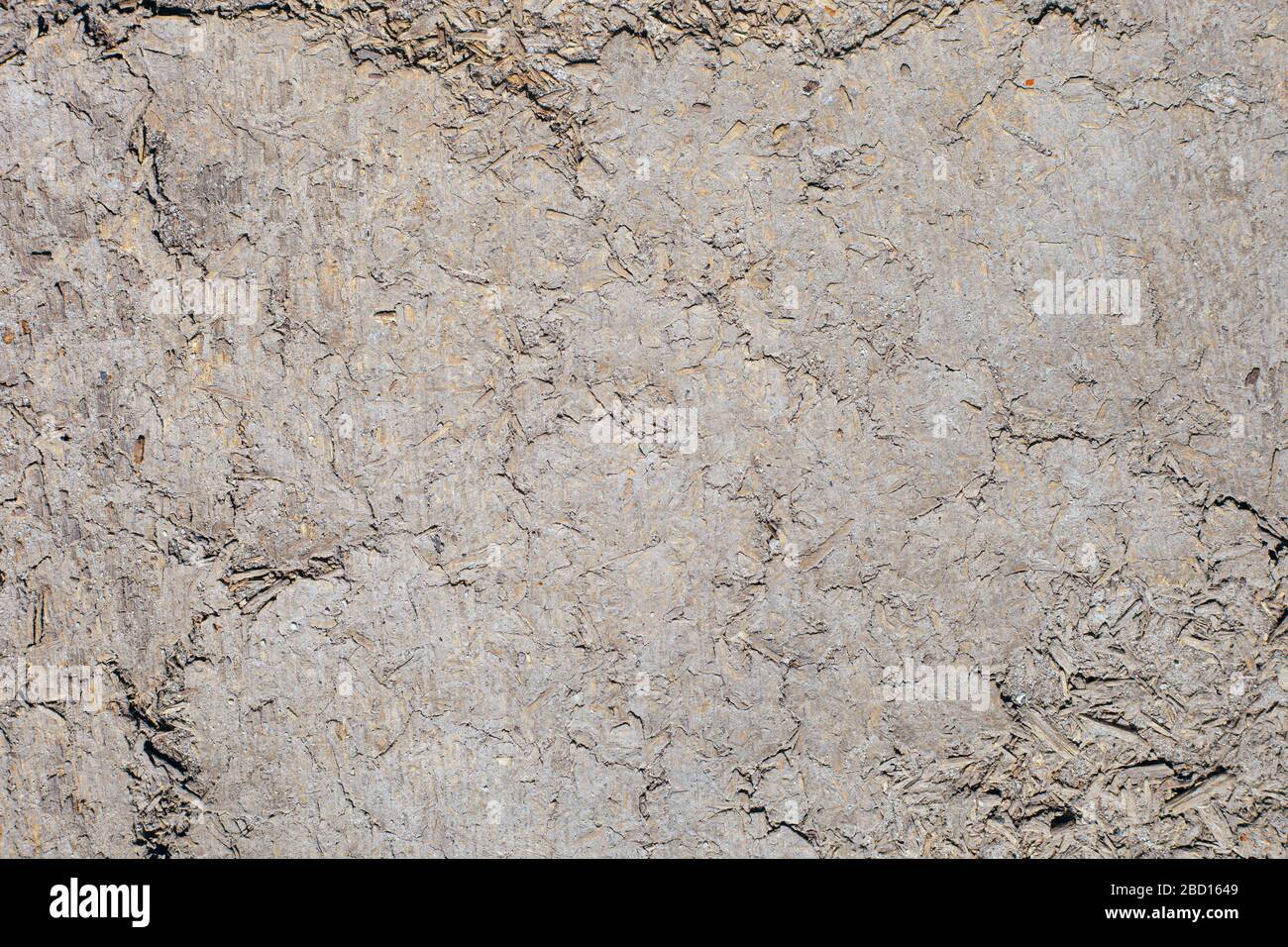Texture of the wall of an old wooden house made of clay and straw. Stock Photo