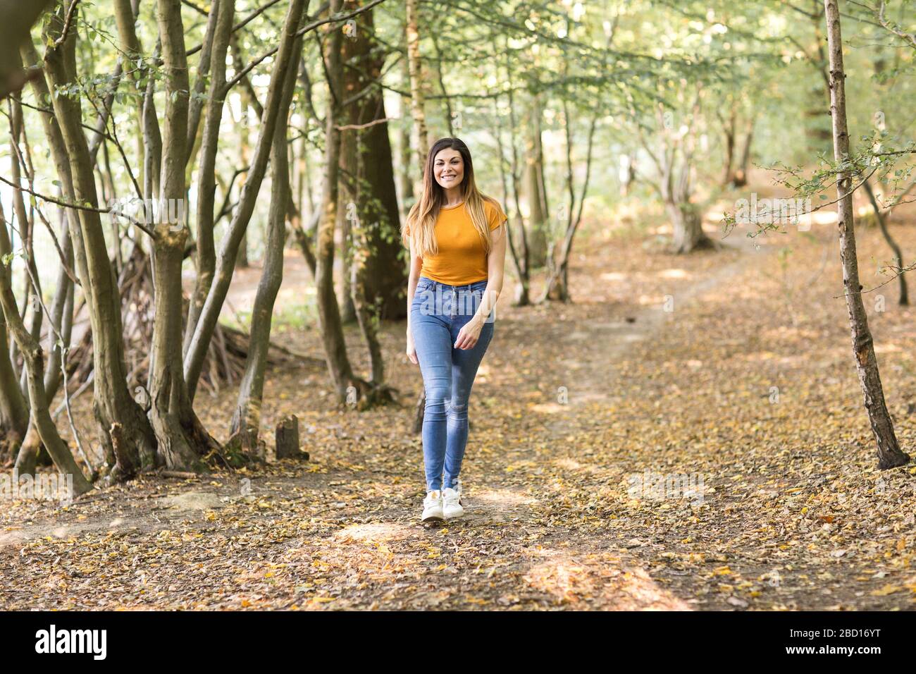 young woman taking a walk in the forest Stock Photo - Alamy