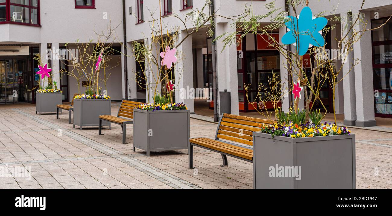 Wooden benches in the town square. Flower beds. Urban greenery Stock Photo