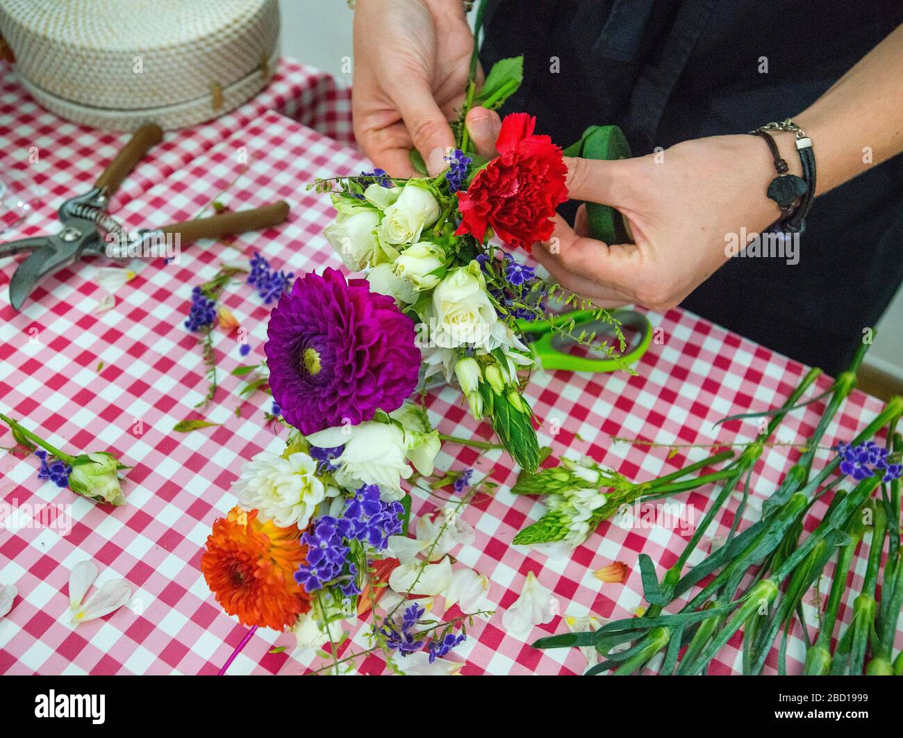 Flower arranging and attaching floral head dress band Stock Photo