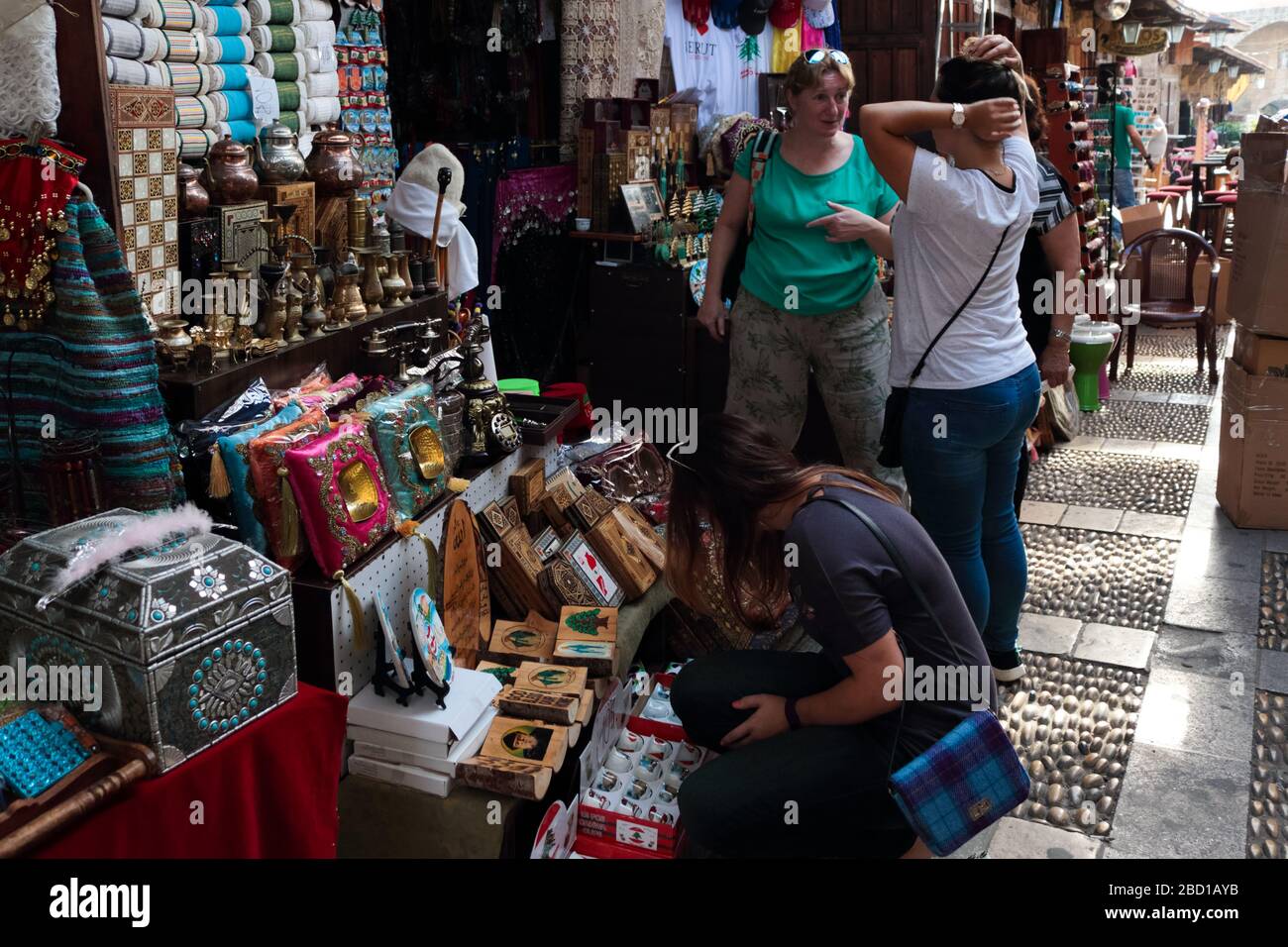 Byblos, Lebanon - May 12, 2017: Foreign travellers visiting a souvenir shops at Byblos souks. Stock Photo