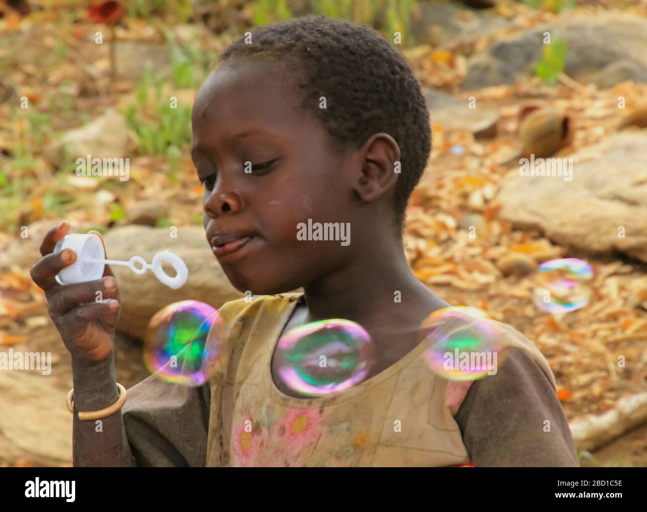 Africa, Tanzania, Lake Eyasi, young male Hadza child plays with soap bubbles. Hadza, or Hadzabe, are an indigenous ethnic group in north-central Tanza Stock Photo