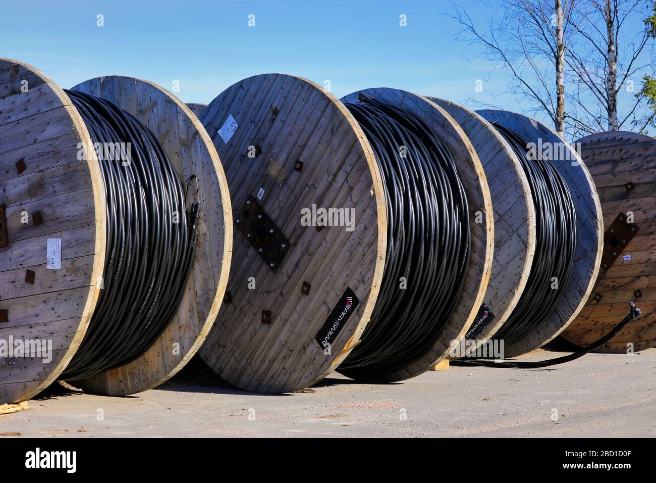 Prysmian Group Wiski Plain cable reels for ground installations at rural work site with blue sky background. Marttila, Finland. April 6, 2019. Stock Photo