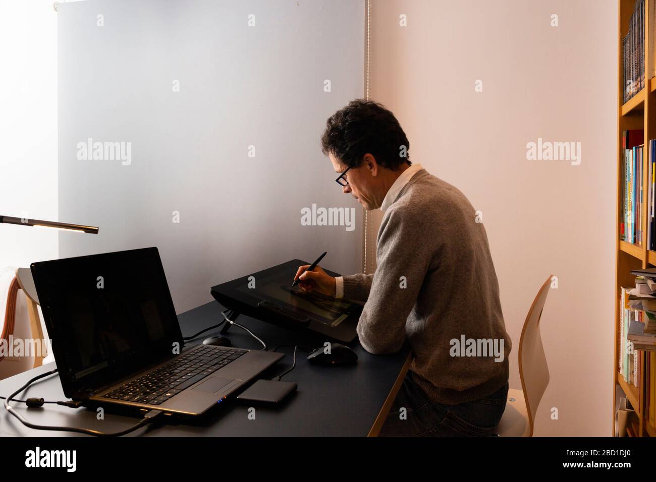 50 year old man working at home, at different times of the day Stock Photo