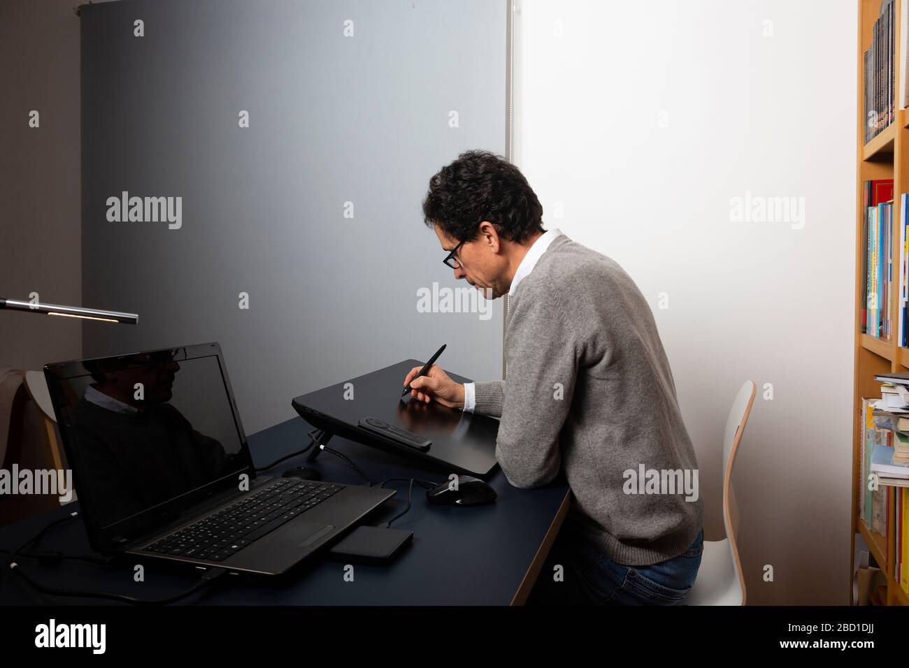 50 year old man working at home, at different times of the day Stock Photo