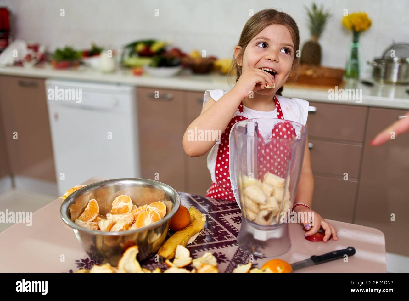 Young girl preparing a smoothie out of many fruits Stock Photo Alamy