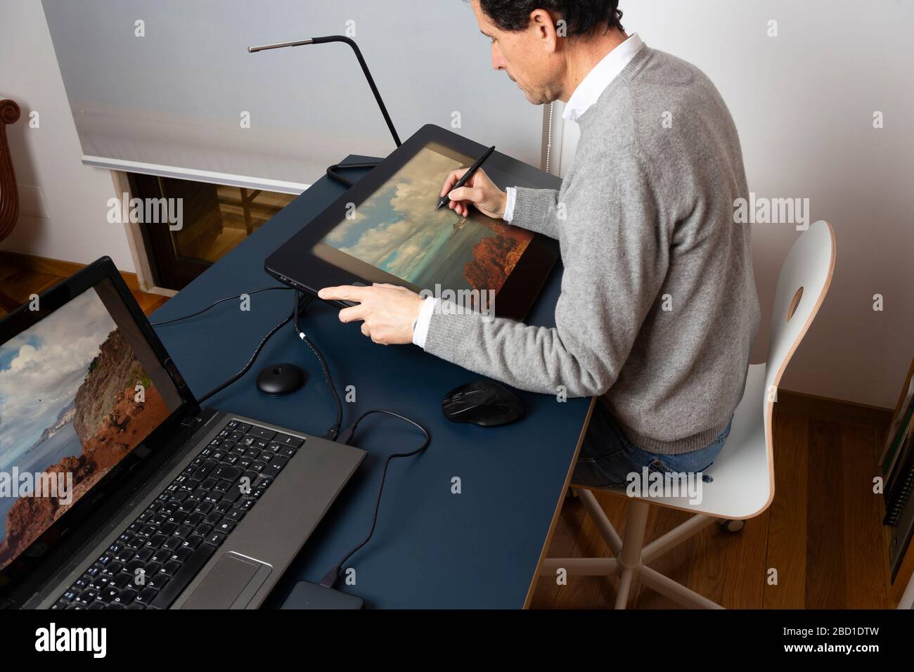 50 year old man working at home, at different times of the day Stock Photo