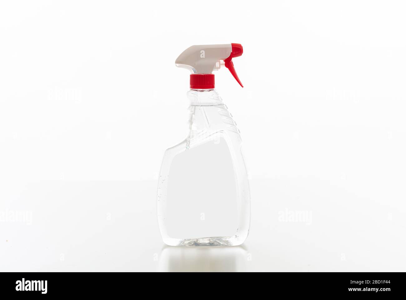 Cleaning spray bottle clear with red trigger isolated against white background. Chemical detergent product no name template, blank empty label, copy s Stock Photo