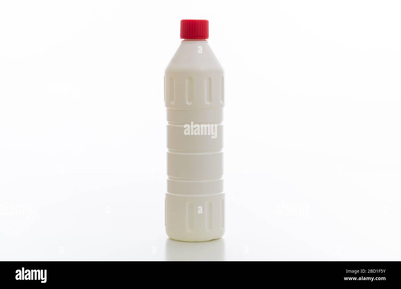 Cleaning chlorine bleach bottle with red cap isolated against white background. Chemical household product for laundry and disinfection, no name templ Stock Photo