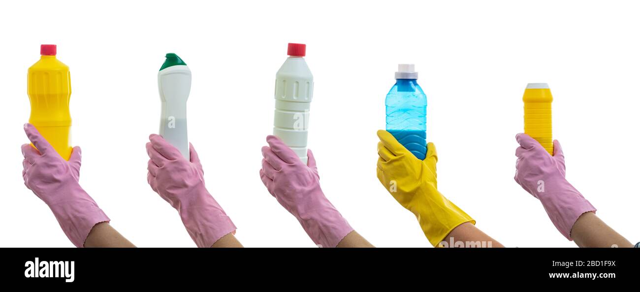Cleaning, hand holding detergent bottles isolated against white background. Cleaner rubber glove with chemical cleaning products collage. Stock Photo
