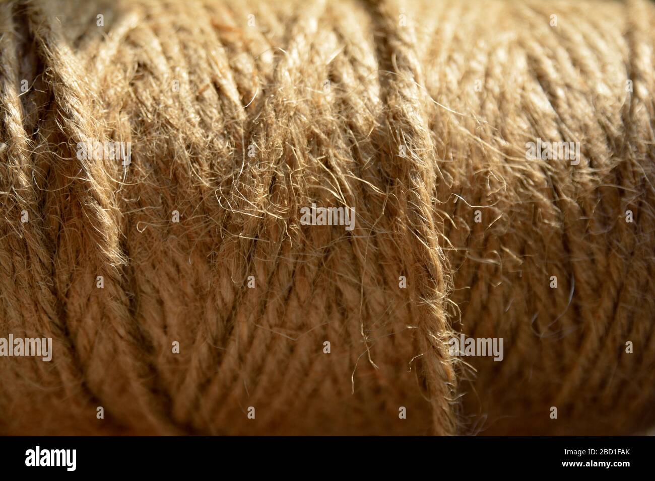 A full frame closeup shot of a roll of natural brown twine Stock Photo