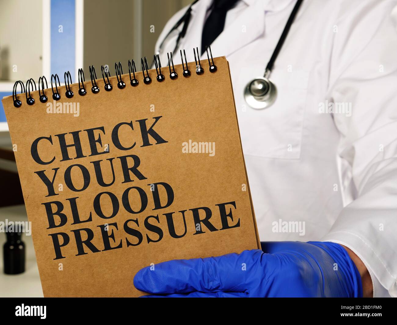 High Blood Pressure Hypertension concept. Man shows sign Check your blood pressure. Stock Photo