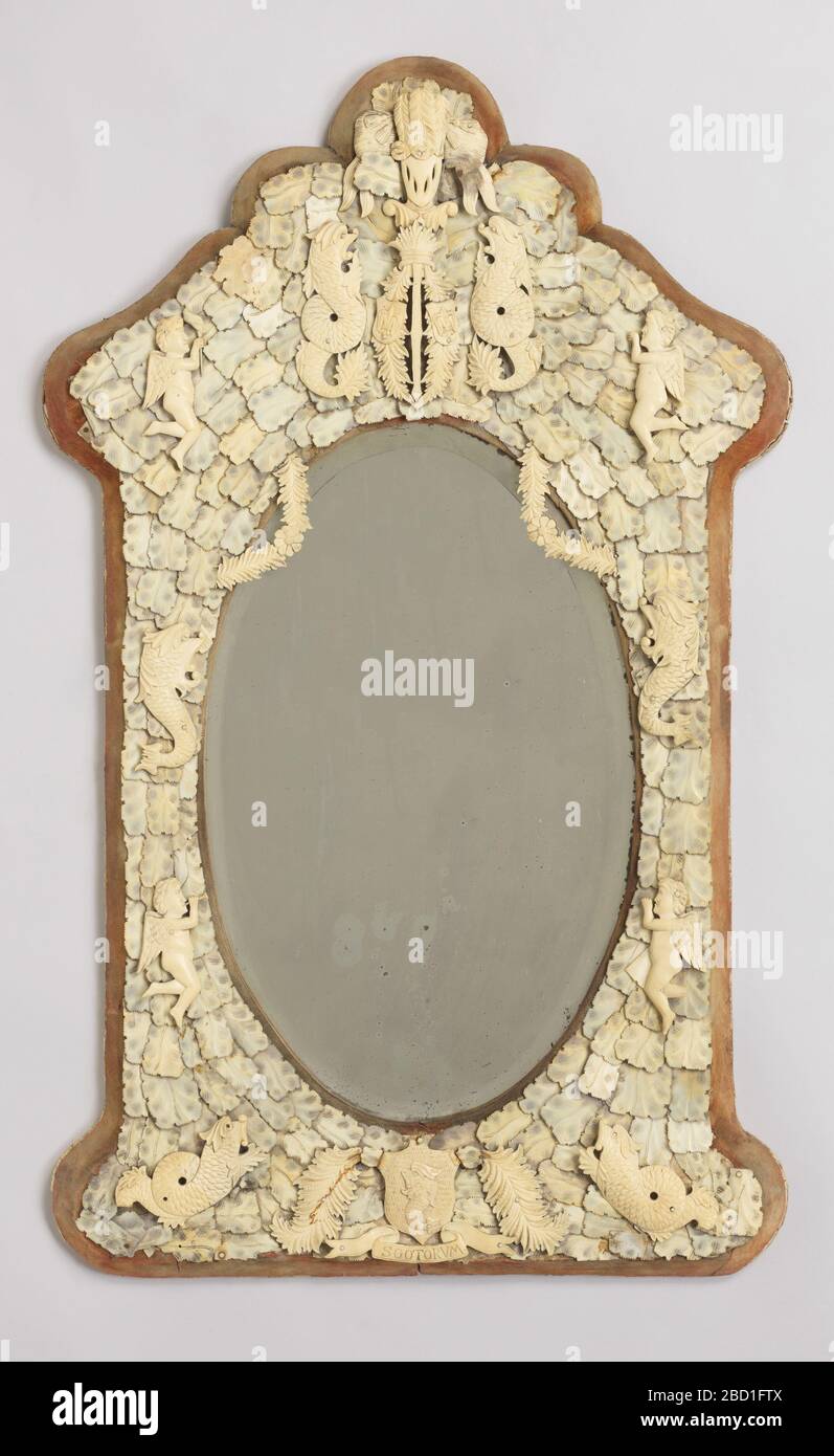 Dieppe. Research in ProgressShield-shaped frame mounted with overlapping plaques of ivory, the arched top with heraldic devices, the bottom overset with fish and a shield, all surrounding an oval mirror. Dieppe Stock Photo