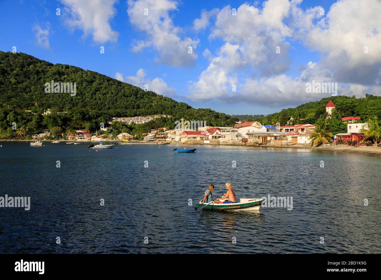 Deshaies waterfront, couple in rowing boat, Death In Paradise location, Saint Marie, Basse Terre, Guadeloupe, Leeward Islands, Caribbean Stock Photo
