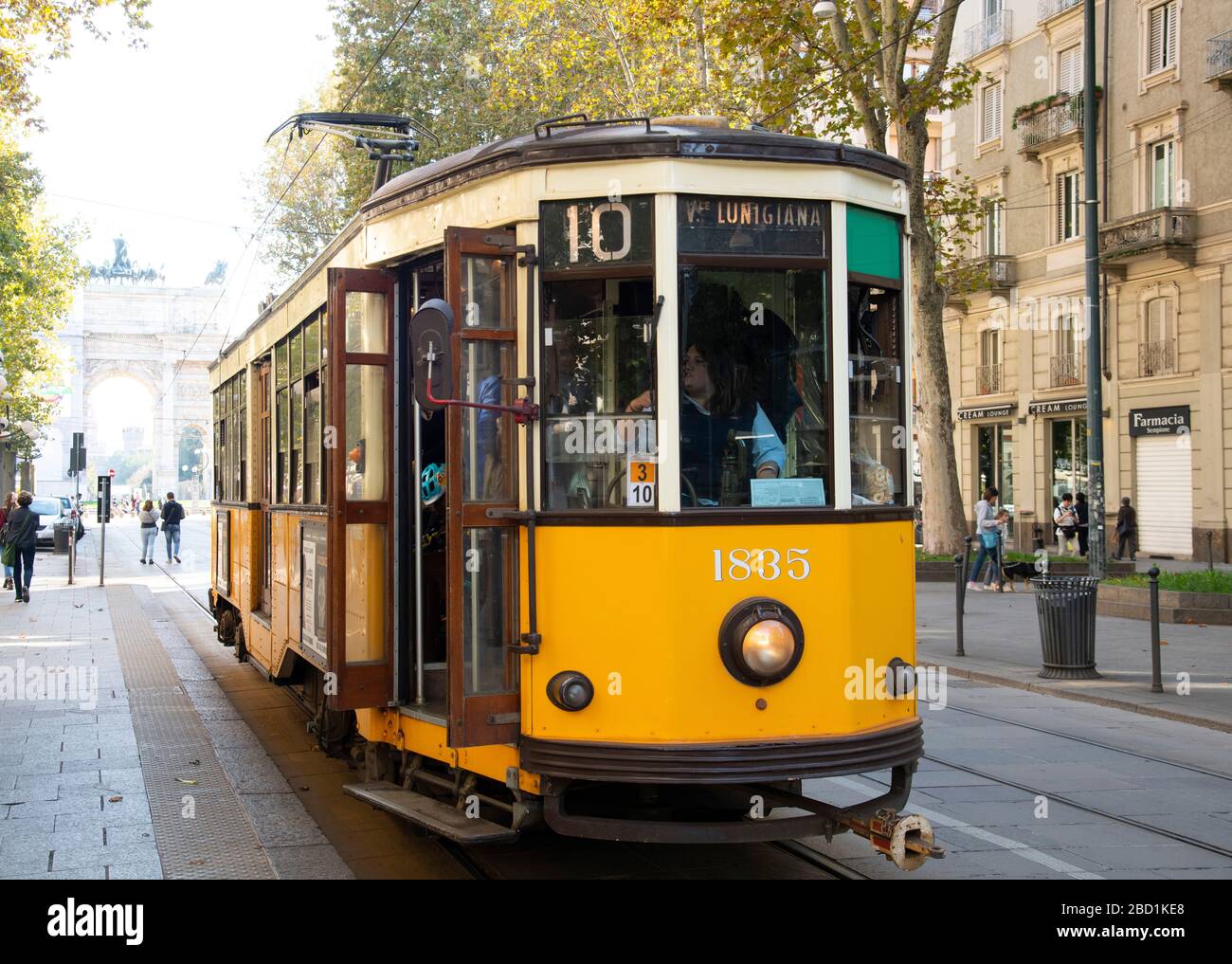 A 1920s yellow electric tram in central Milan, Lombardy, Italy, Europe Stock Photo