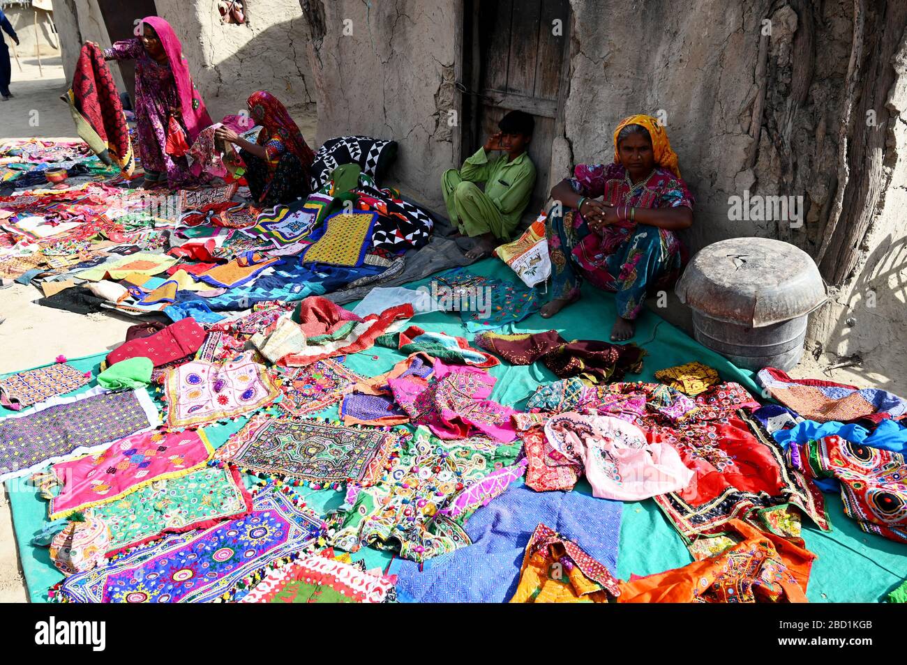 Women displaying their hand embroidered cloths, garments and bags in the desert village of Jarawadi, Kutch, Gujarat, India, Asia Stock Photo