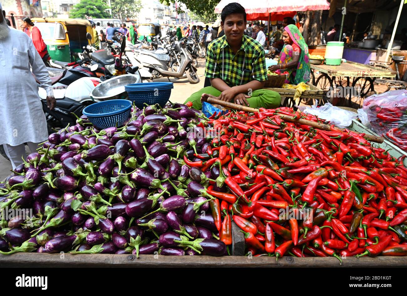 Man selling aubergines and capsicum on street barrow in the market, Gondal, Gujarat, India, Asia Stock Photo