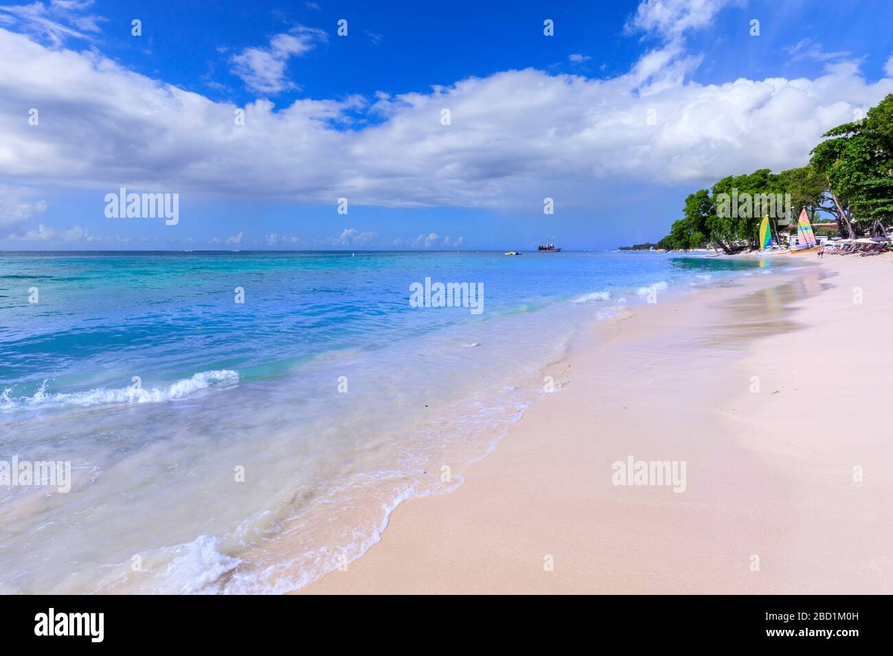 Paynes Bay, small colourful sail boats pulled up on fine pale pink sand beach, beautiful West