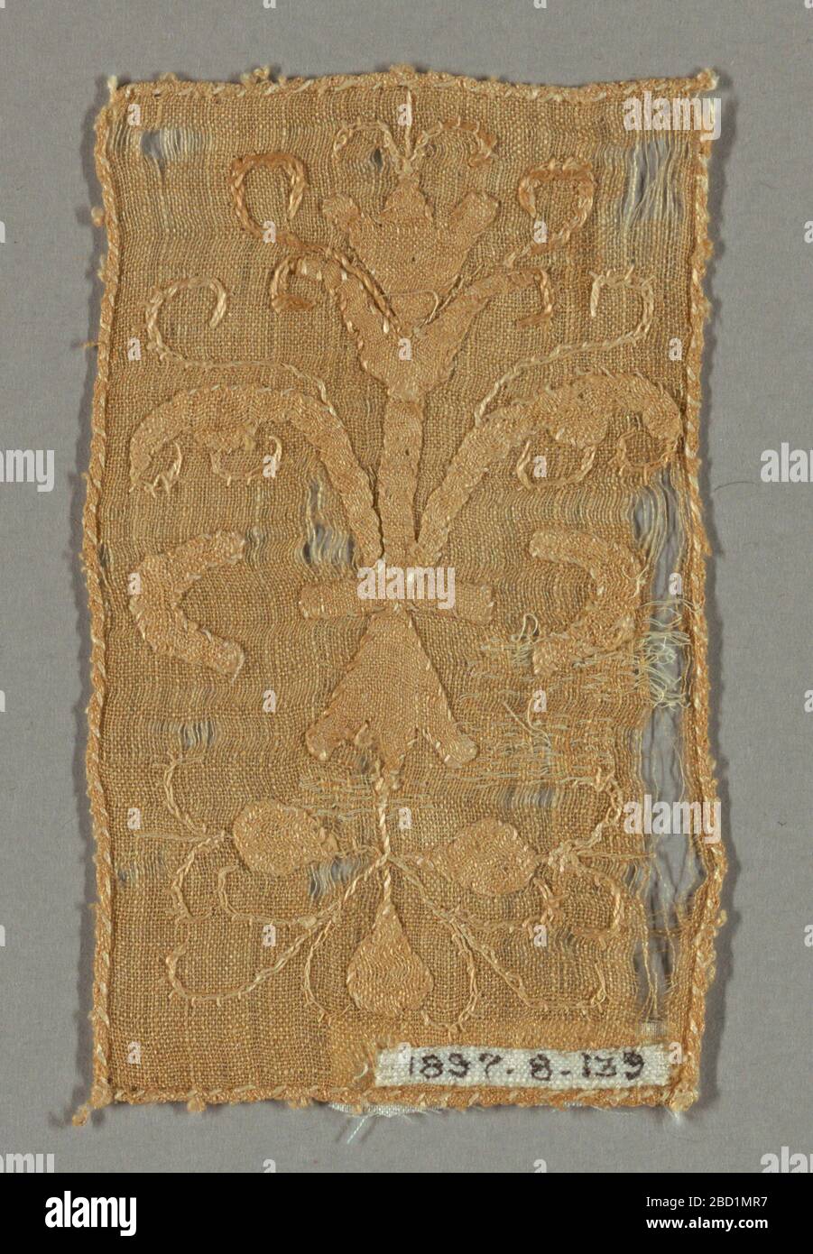 Fragment. Research in ProgressLight brown rectangular fragment in a conventionalized design of scrolling leaves and floral forms. Fragment Stock Photo