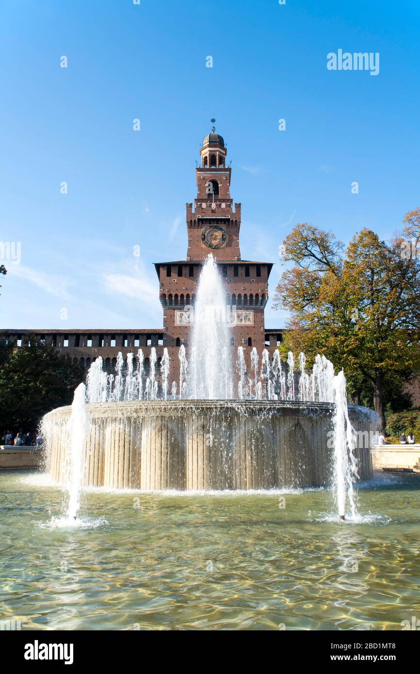 A fountain in front of the Torre del Filrete clock tower on the Castello Sforzesco, Milan, Lombardy, Italy, Europe Stock Photo