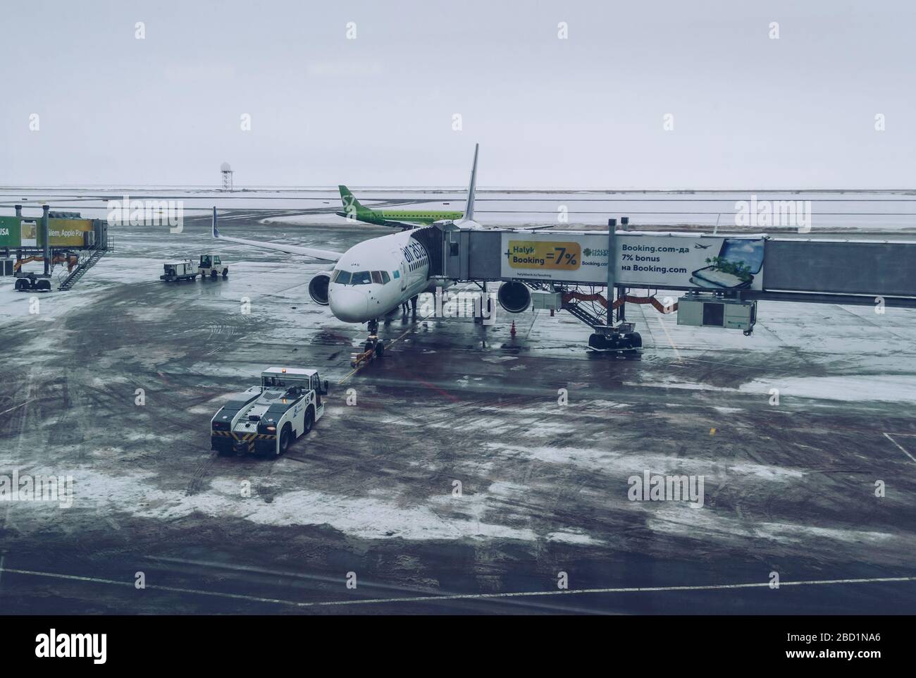 Nur-Sultan, Kazakhstan, 04 January, 2020: airplane is being managed by airport workers on cold winter day Stock Photo
