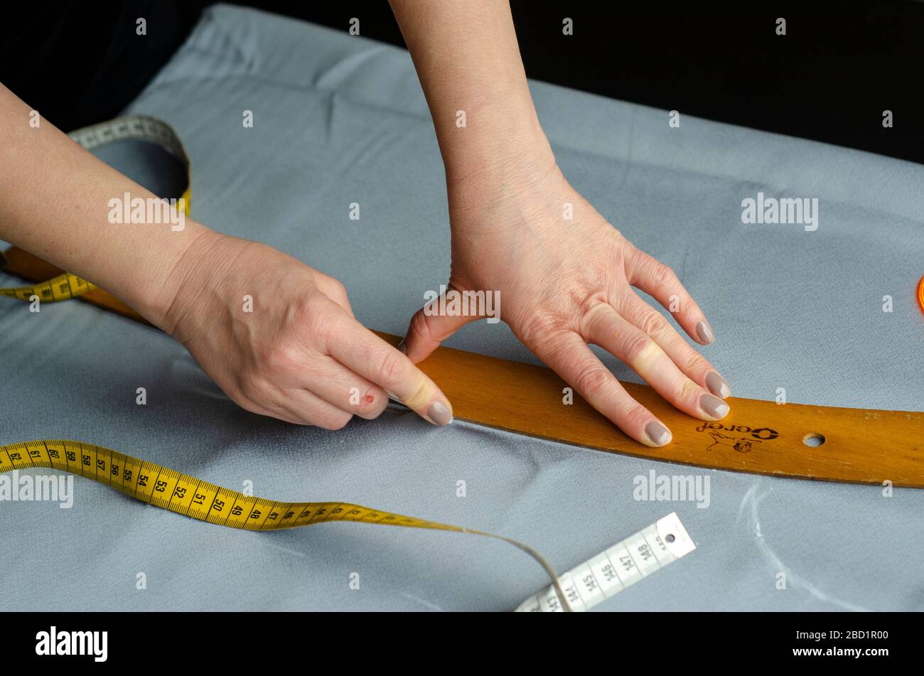 Seamstress using measuring tape Stock Photo by DC_Studio