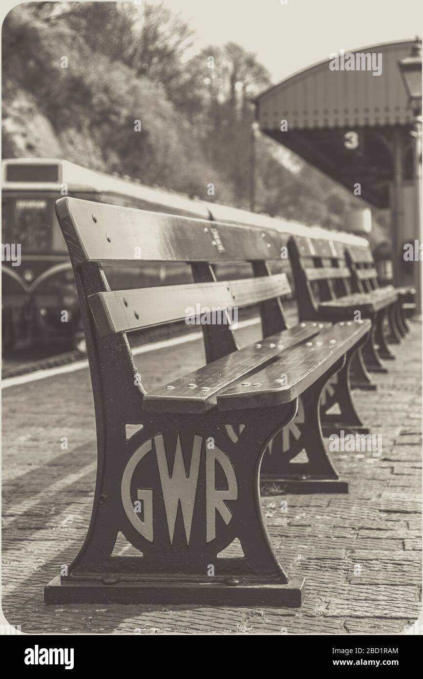 Black and white close up, vintage GWR railway bench, on platform at