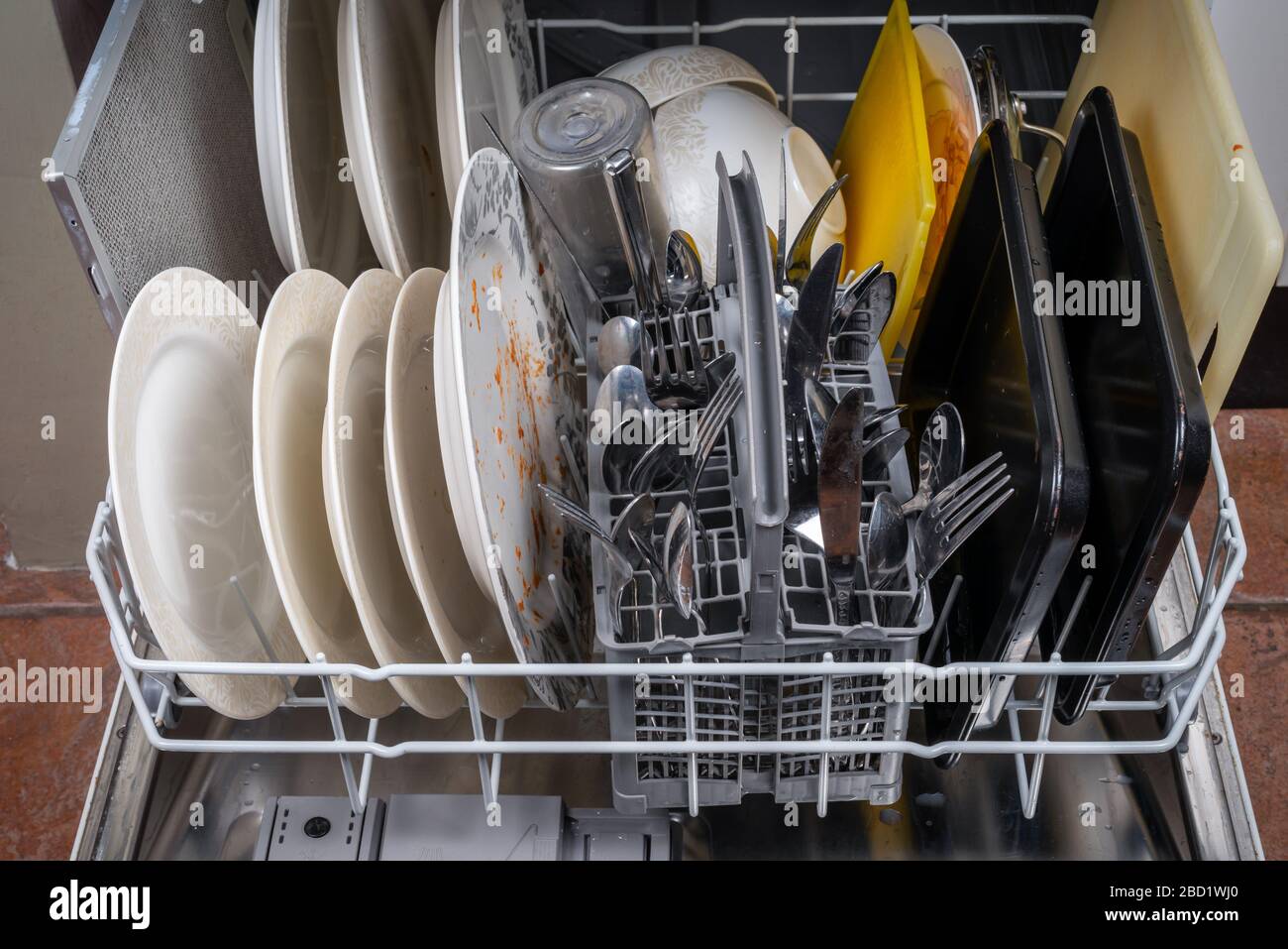 A dishwasher loaded with dirty dishes Stock Photo Alamy