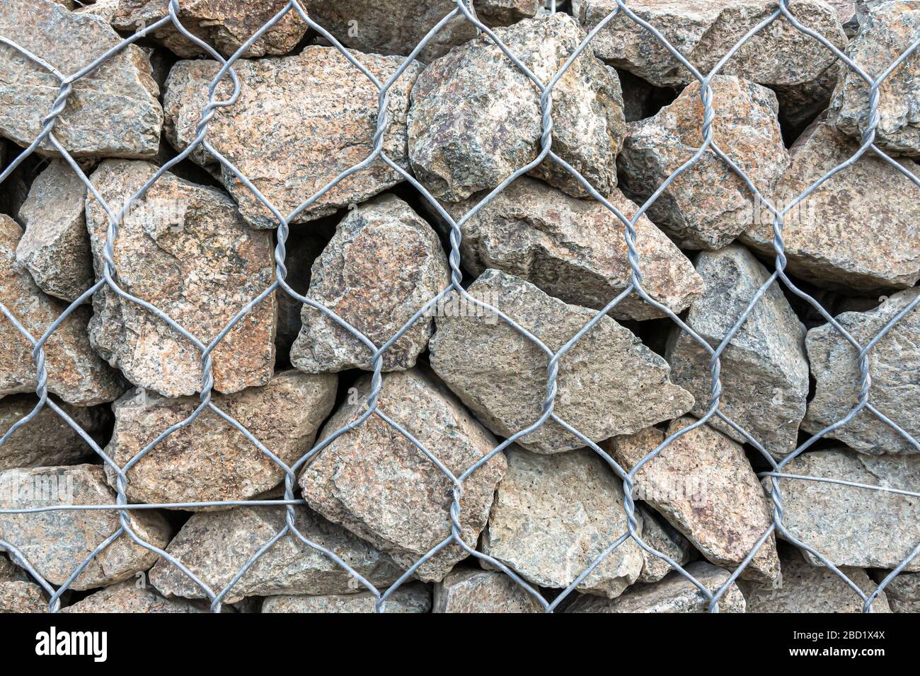 Stone Net Backing textural background - granite stone behind a mesh netting, wall Stock ...