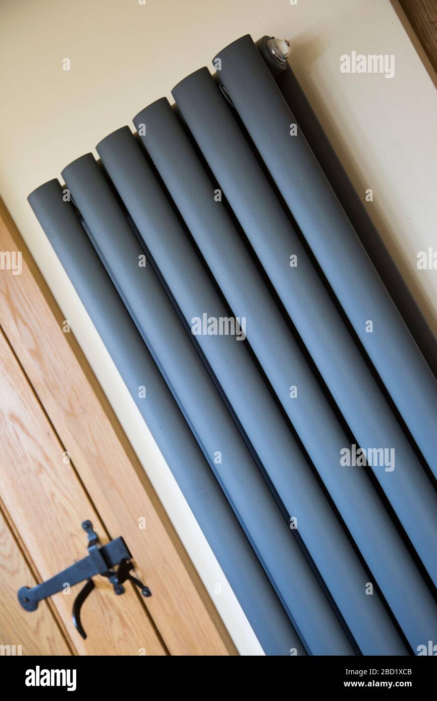 Vertical Radiator on kitchen wall, dark grey vertical radiator in a country farmhouse kitchen