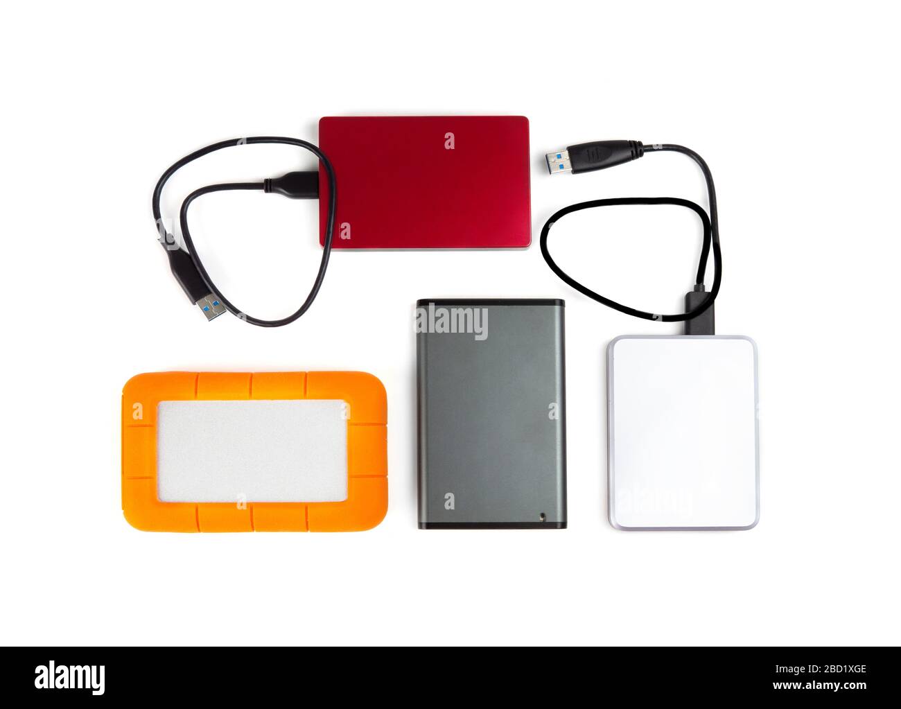 Four portable hard disk drives of different colors and sizes isolated