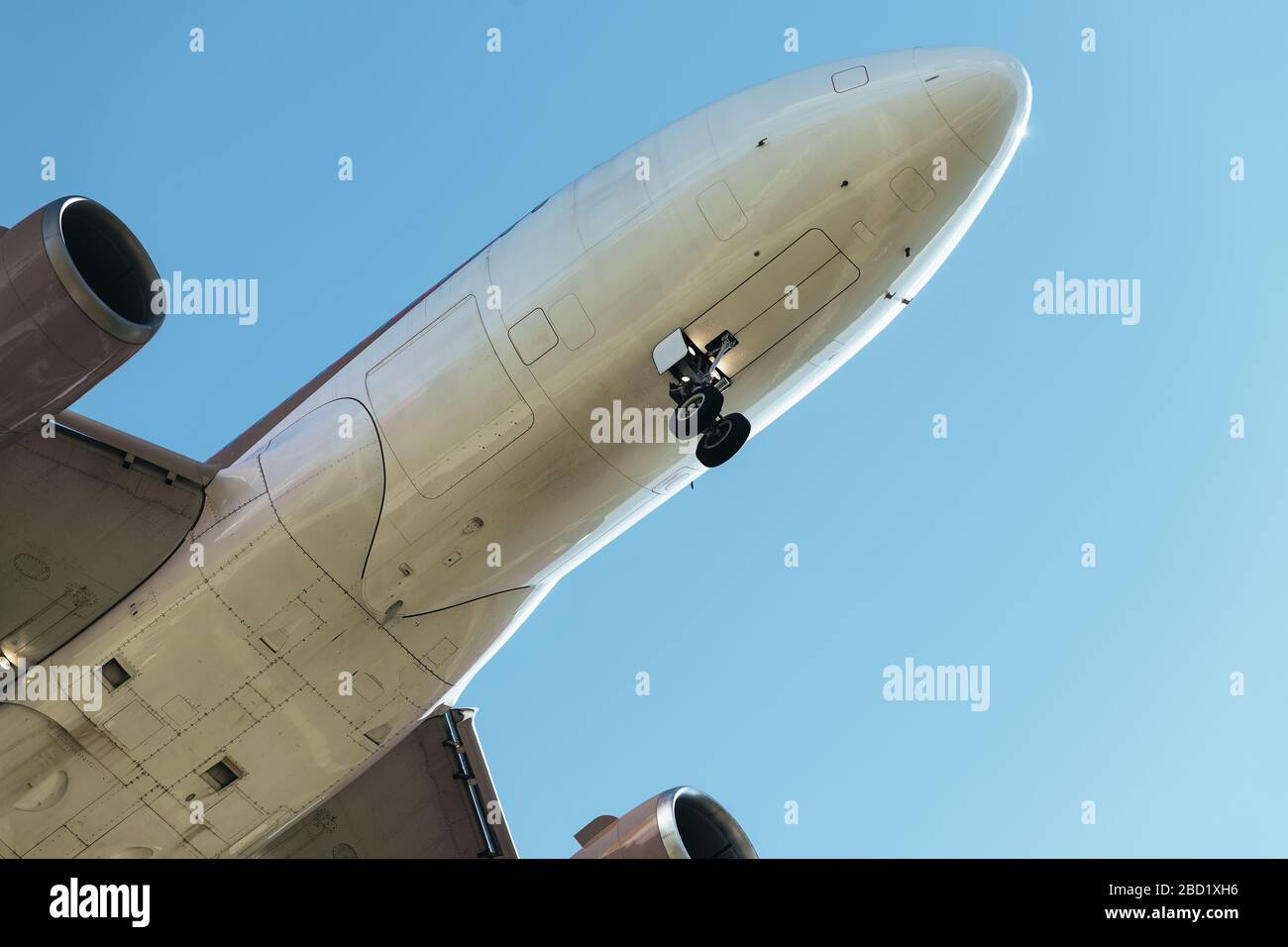 detail of the nose of a plane flying seen from below with the landing