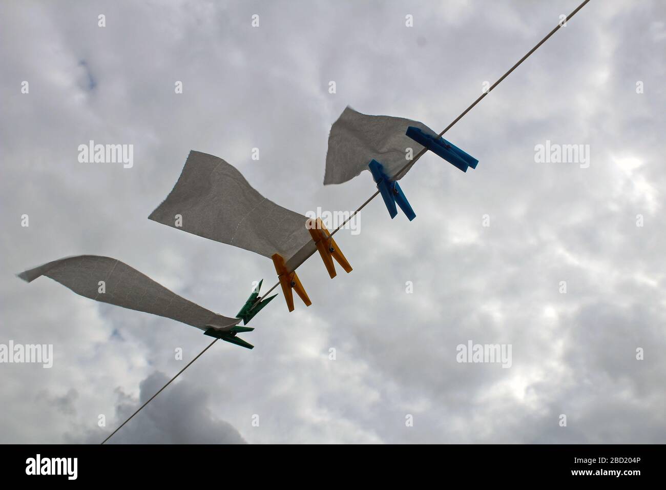 A washing line used for drying toilet paper on a windy day Stock Photo