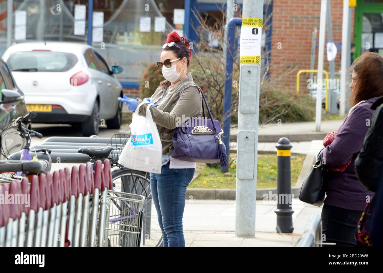 Lady in Supermarket queue, in anti virus mask Stock Photo