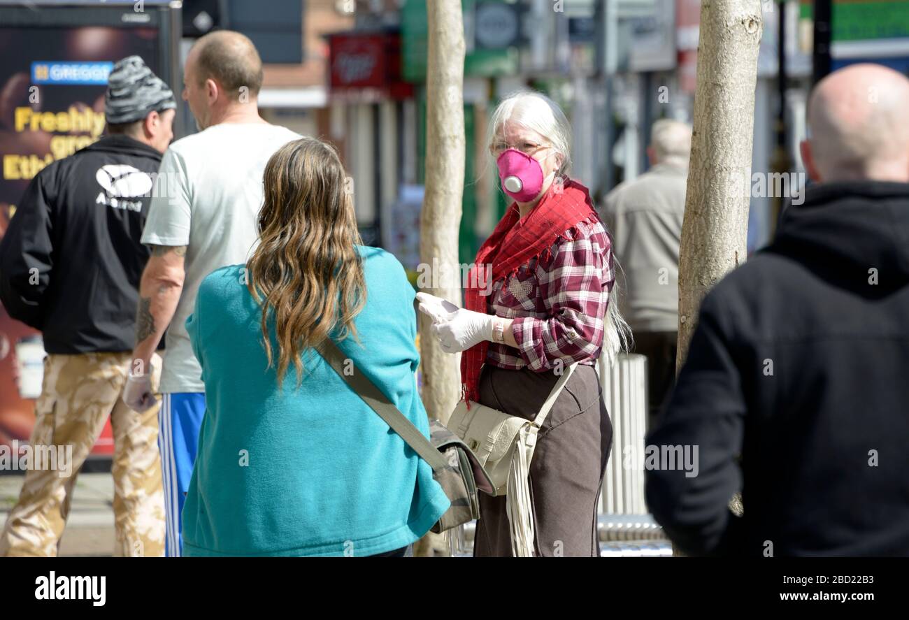 Lady in Supermarket queue, in anti virus mask Stock Photo