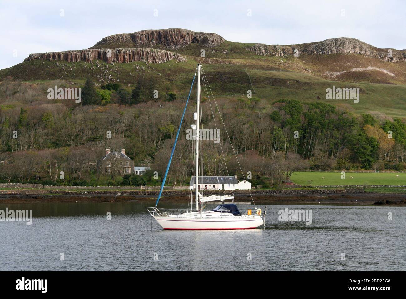 Sailing yacht anchored in Canna harbour, Canna, Hebrides, Scotland Stock Photo