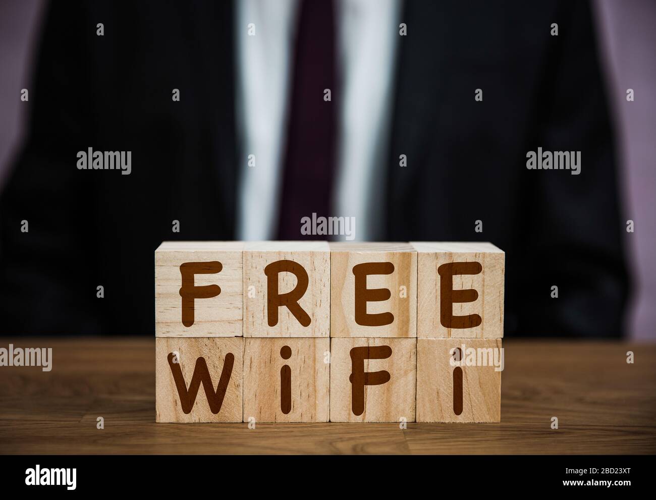 A sign saying Free Wifi for customers of hotels, retail and internet cafe in an internet, broadband connectivity background with copy space Stock Photo