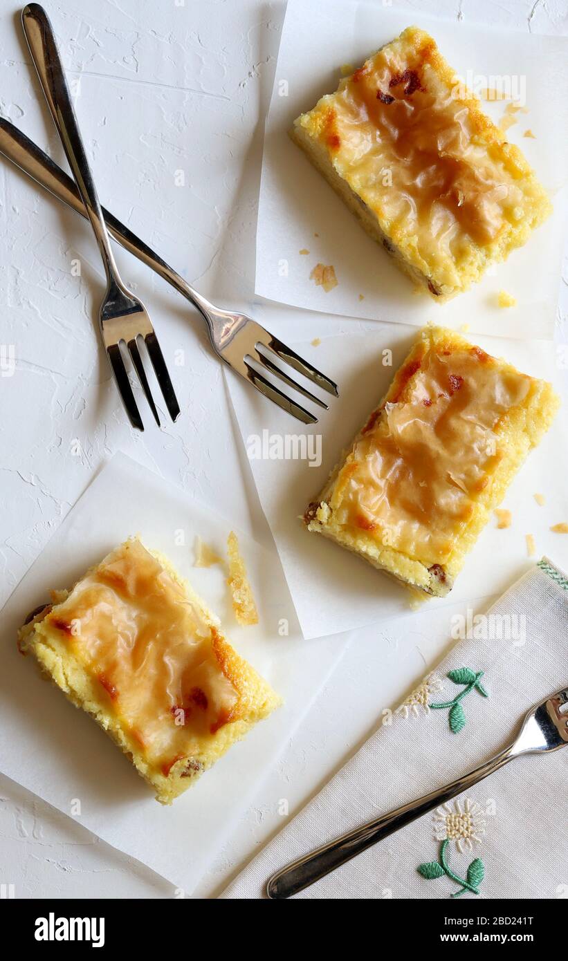 Pieces of homemade traditional Greek pastry  - Bougatsa pastry made of phyllo dough and custard. Top view. Stock Photo