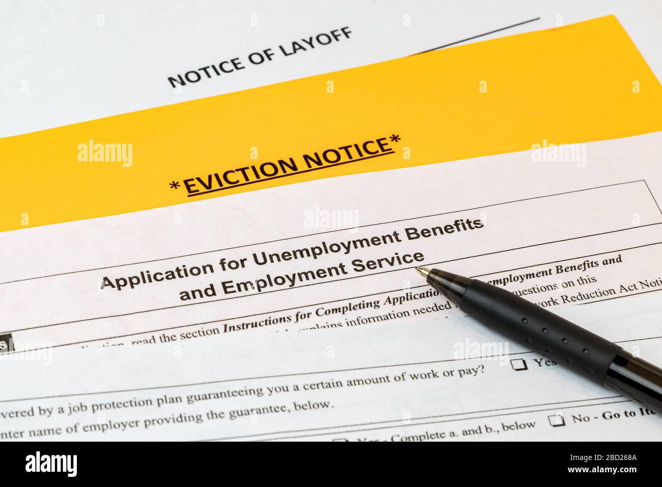 Job layoff notice, application for unemployment insurance benefits, eviction notice. Covid-19 coronavirus stay at home order effect on economy Stock Photo