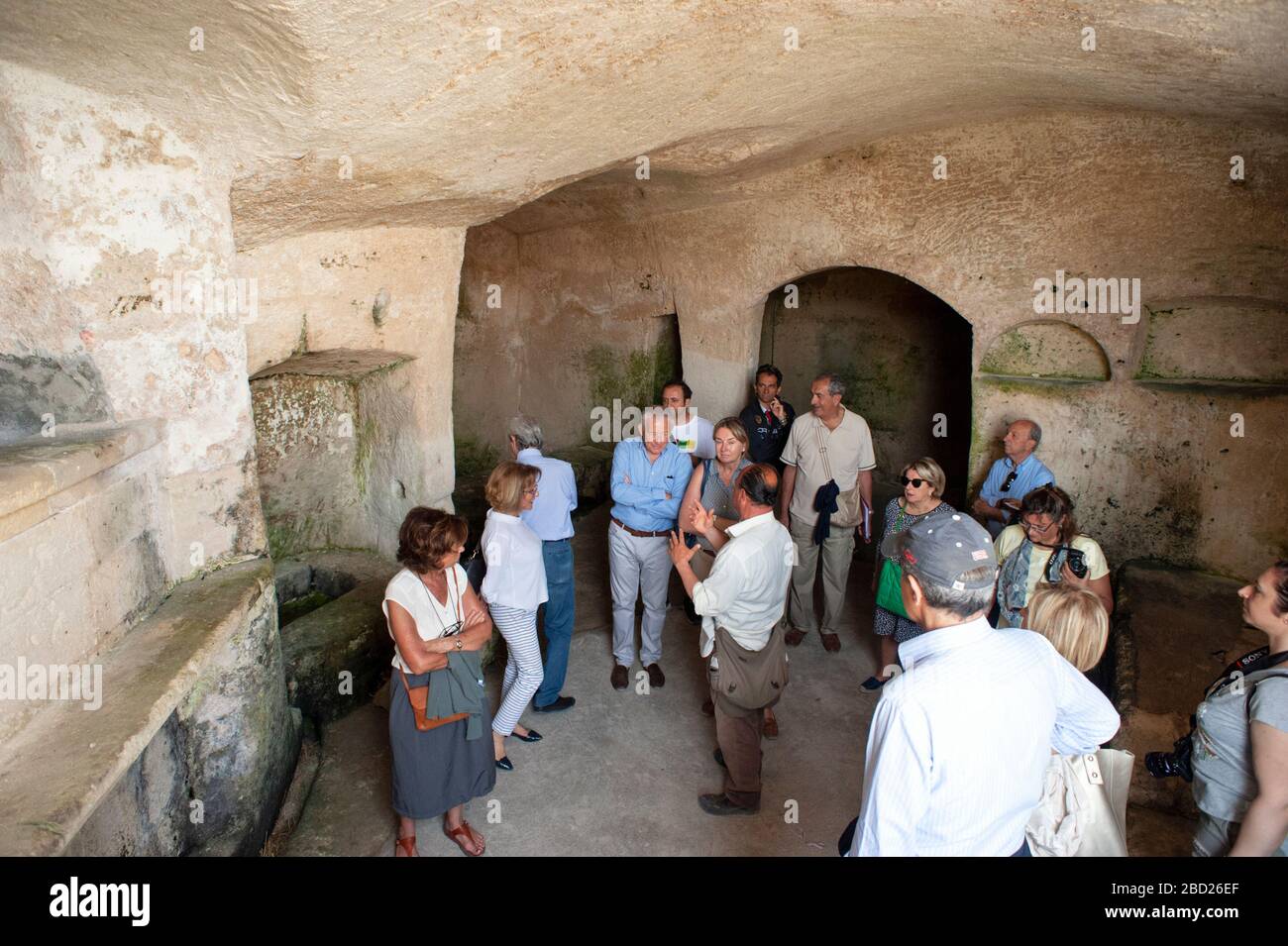 Italy, Basilicata, Matera, Sassi, Sasso Caveoso, cave, tourist group Stock Photo