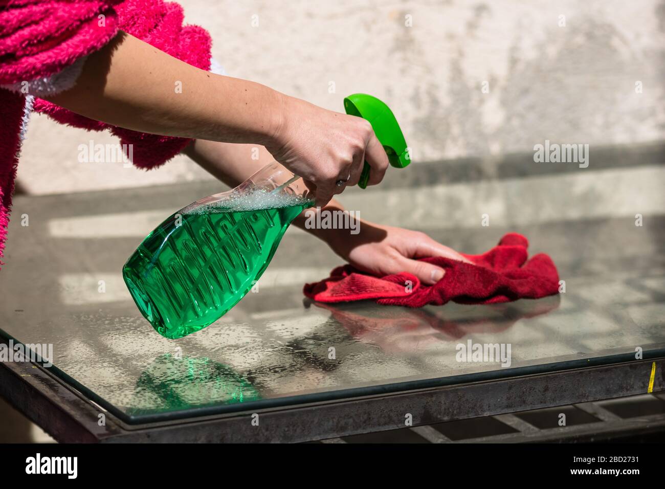 Woman cleaning glass table red microfiber rug and cleaning sprayer, cleaning  services concept. Housework and housekeeping concept Stock Photo - Alamy