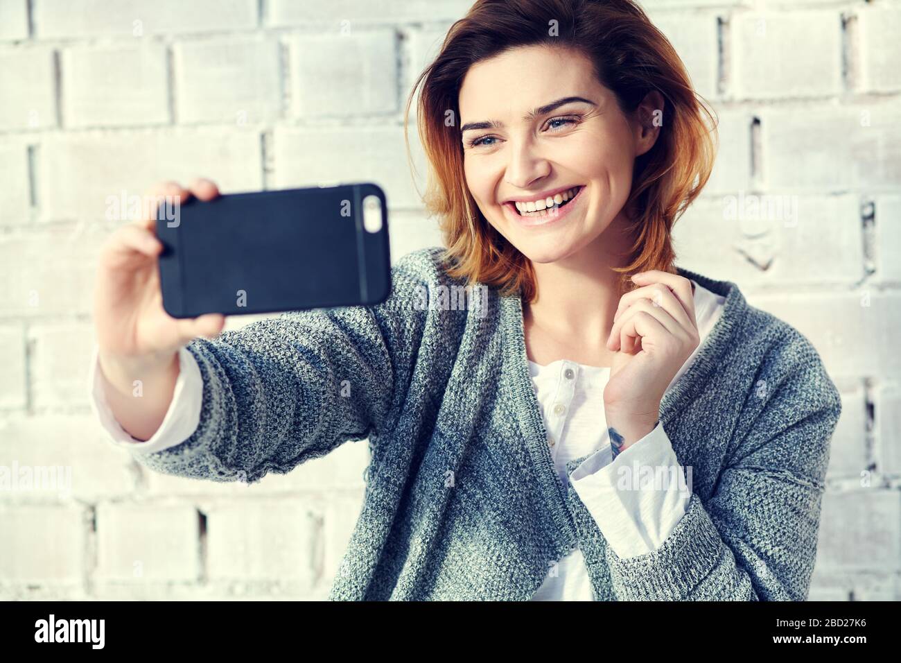 young attractive woman taking selfie photo at home Stock Photo - Alamy