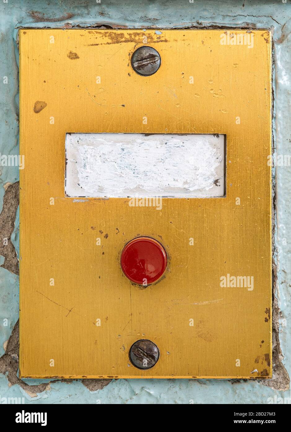 old doorbell plate with blank erased label and red button Stock Photo