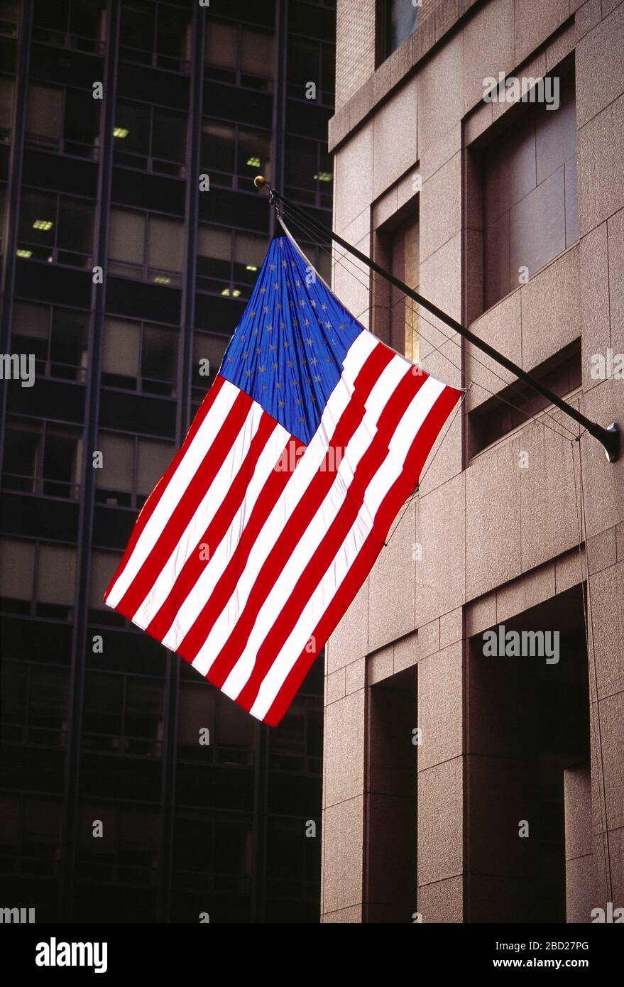 USA. New York. Manhattan. Stars and Stripes flag on building side flagpole. Stock Photo