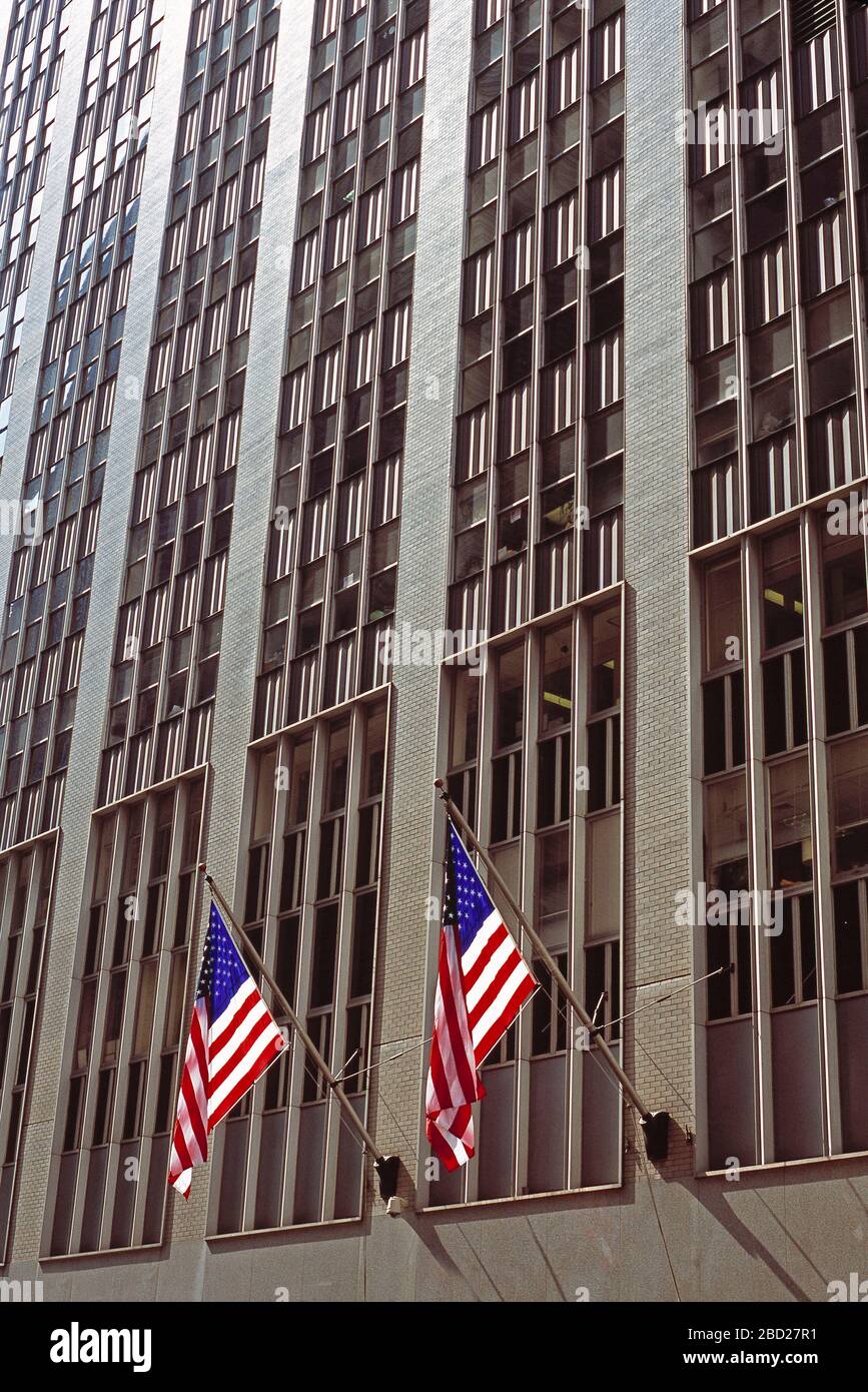 USA. New York. Manhattan. Commercial skyscraper with American flags. Stock Photo