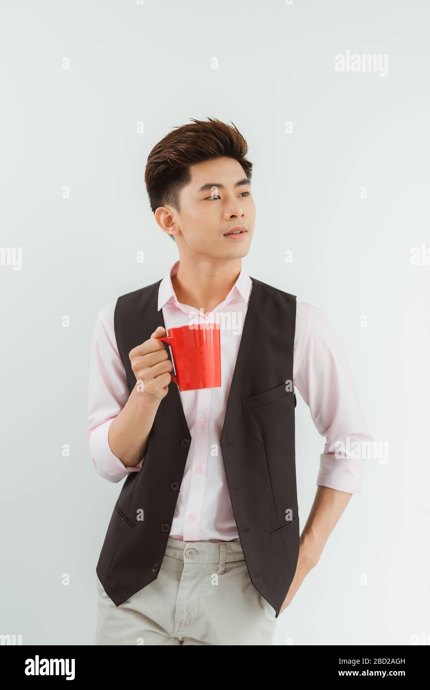 Portrait Handsome Asian boy holding coffee cup over white background Stock Photo