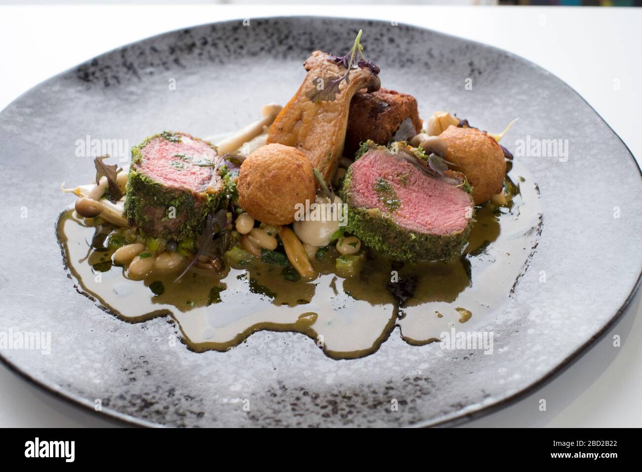 Herb-crusted lamb striploin with cassoulet at The Beach at Bude hotel restaurant in Bude, north Cornwall Stock Photo