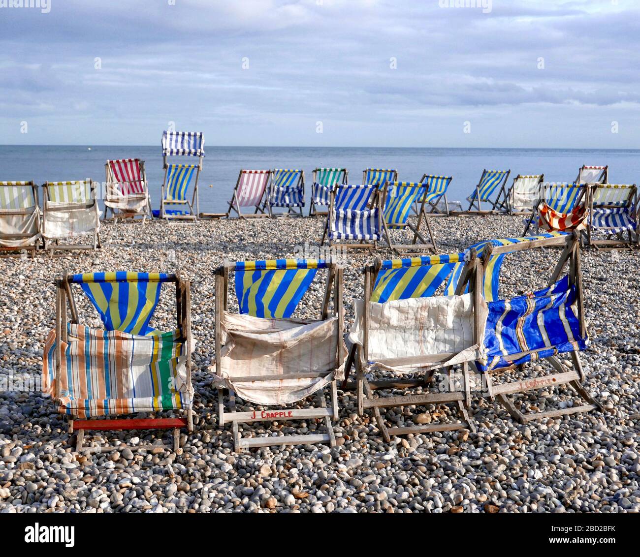 Deck chairs on the beach at Beer, East Devon Stock Photo
