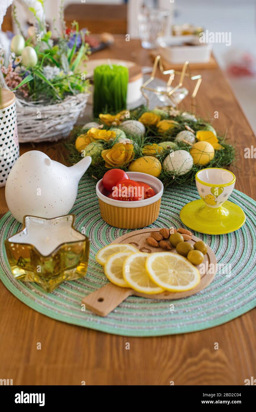 Dyed Easter eggs with snacks. Easter table decorations. Stock Photo